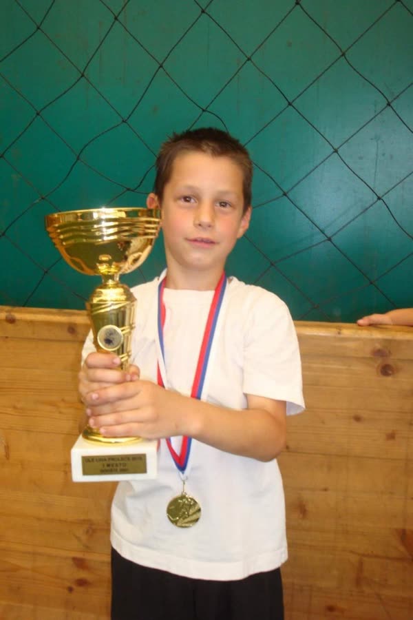 Marko as a kid holding a trophy