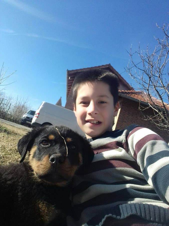 Marko as a kid with a puppy